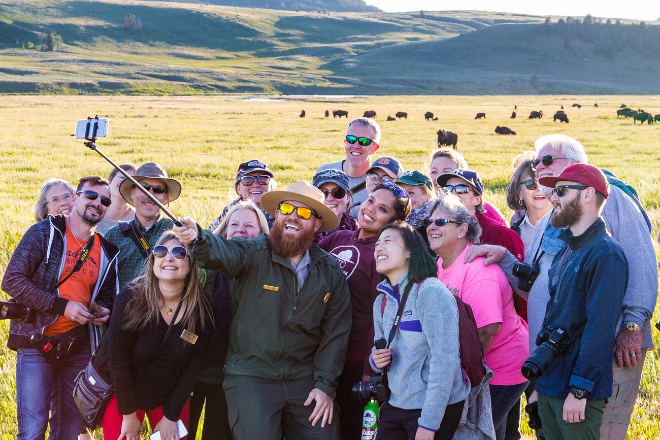Safe Selfie at Yellowstone, NPS/Matt Ludin A park ranger and a group of visitors take a safe selfie at Yellowstone. Bison are seen in the background at least 25 yards away.